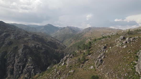 Rugged hills against cloudy sky, Peneda-Gerês National Park. Aerial forward