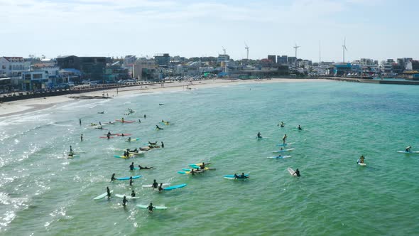 Landscape with people enjoying surfing on the blue sea, Jeju Island alt