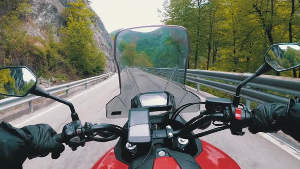 Motorcyclist on Motorbike Rides on a Beautiful Landscape Mountain Road in Italy alt