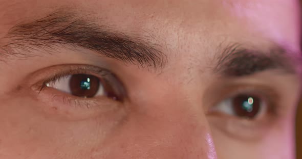 Closeup of a Young Man Eyes Look at the Monitor Work with a Computer Laptop alt