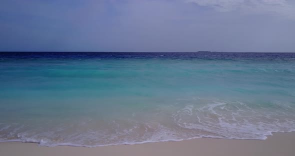 Beautiful fly over island view of a white sand paradise beach and aqua blue ocean background in colo alt