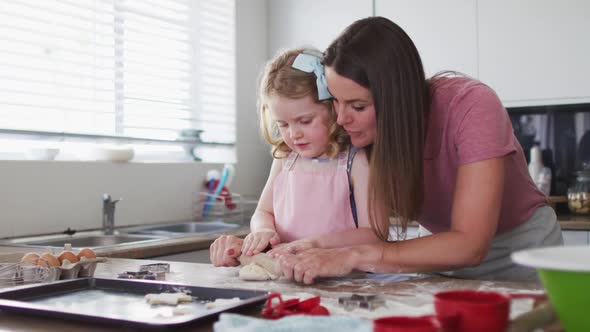 Caucasian mother and daughter having fun cooking together alt