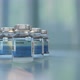 New vaccine reveal in ampule vial close-up on a laboratory table - VideoHive Item for Sale