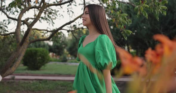 Beautiful Woman Walking in a Park in the Dress alt
