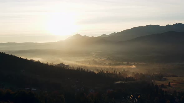 Aerial Flight Over Amazing Mountains Lit with Warm Morning Sunlight alt