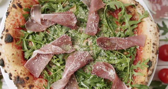 Delicious Pizza with Prosciutto Parma Ham Arugula Salad Rocket with Ingredients alt