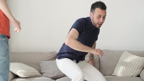 Happy Parents with Cute Children Relax on the Couch Laugh Have Fun Play at Home alt