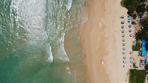 Aerial view of white sand beach and ocean wave alt