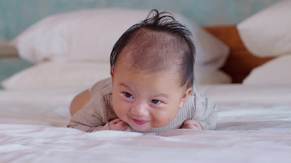 Newborn baby 4 month laying on stomach developing neck control .tummy time alt