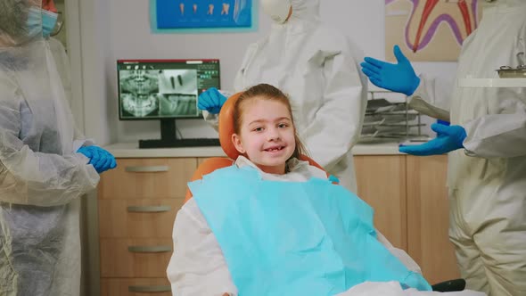 Close Up of Happy Girl Laughing at Camera Visiting Dentist During Global Pandemic alt