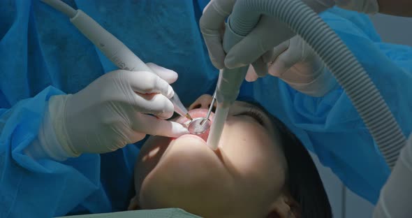 Woman undergo dental check up in clinic alt