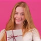 Red Haired Woman Offers Christmas Gift Box While Looking in Camera with a Smile - VideoHive Item for Sale