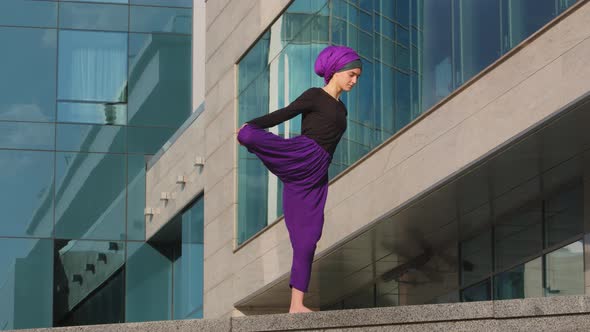 Strong Calm Woman Muslim Islamic Girl in Hijab Barefoot Lady in Purple Pants Stands City Building alt