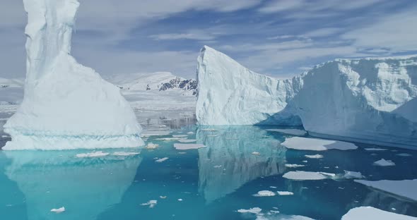 Tabular Icebergs Melt at Turquoise Ocean Bay Aerial. Huge High Ice Glacier, Polar Nature Environment alt