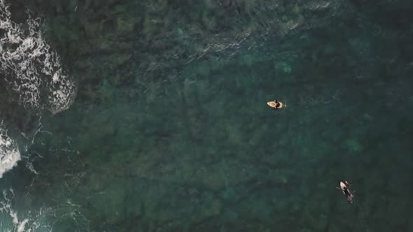 Aerial view of a man surfing at an agitated sea near Losinj coastline, Croatia. alt