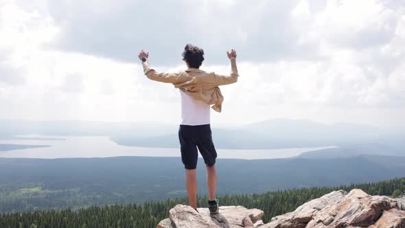 A Young Man on Top of a Mountain
