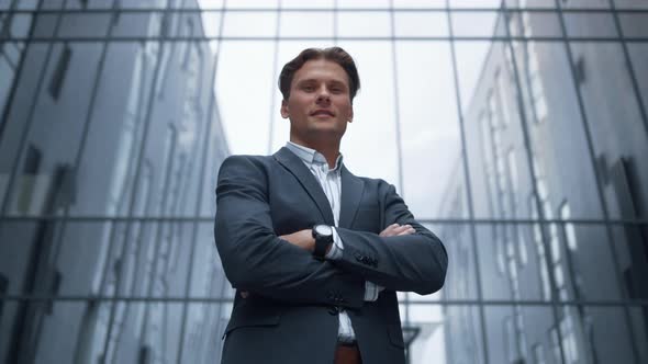 Portrait Smiling Businessman Standing Outside Glass Office Building Alone alt