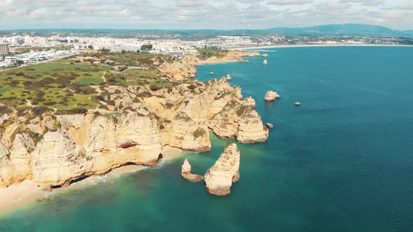 Sweeping view over Rugged sandstone cliffs lining Lagos coast, Algarve, Portugal alt