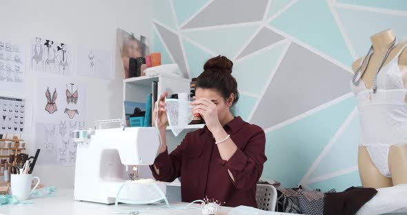 Seamstress Working in Her Atelier Studio with Sewing Machine alt