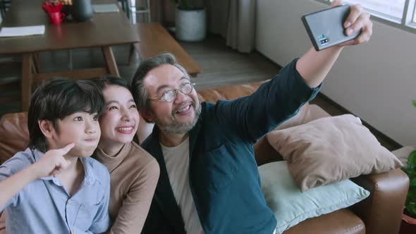 happiness joyful family love concept Asian family holiday activity dad holding smartphone