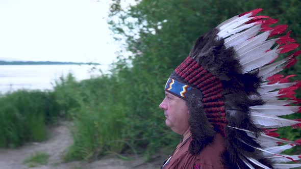 Old Native American Indians Stands on the Background of the River Background of the River. alt