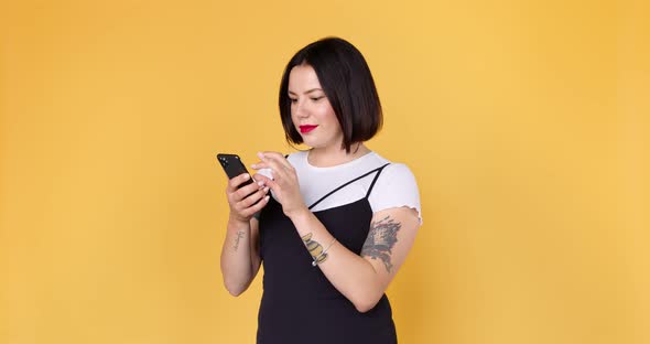 Young single woman using dating app on phone, swiping and touching screen, enjoys. alt