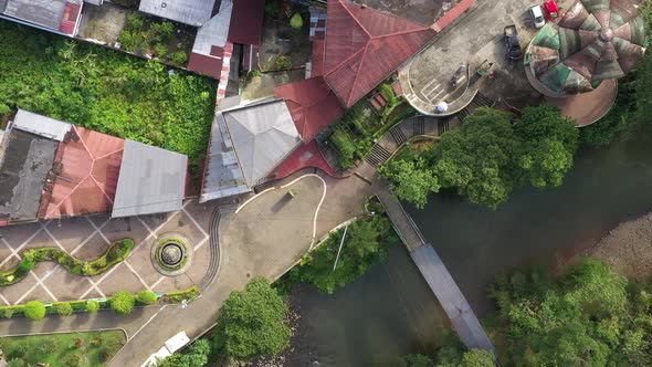 Bird eye view of an area within a city alongside a river alt