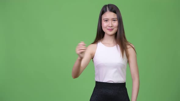 Young Beautiful Asian Businesswoman Showing Something