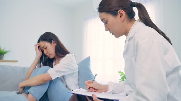 Asian psychology doctor examine and listen to woman patient at home. alt