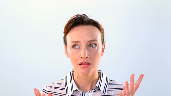 Shocked woman standing against white background alt
