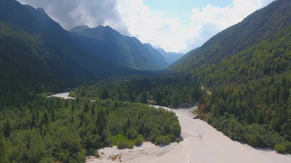 Aerial View of Dry Riverbed Near Lake Predil and Mountains in Background, Alps, Italy alt