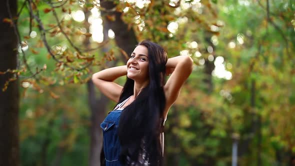 Young happy woman in in autumn park