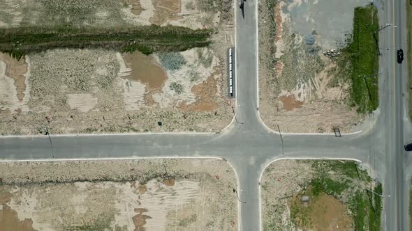 Top down aerial of neighbourhood in pre construction empty lots and home alt