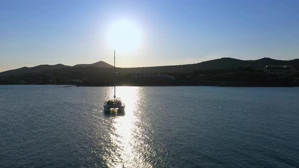 Catamaran Sail Yacht Anchored on Deep Blue Sea Water alt