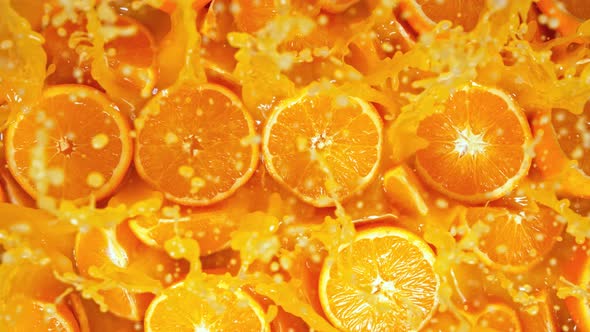 Super Slow Motion Shot of Fresh Orange Juice Splashing Through Orange Slices at 1000Fps alt