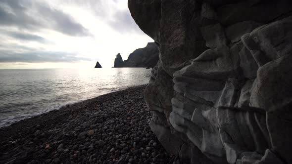 View From the Stone Cave on the Sunset Sea and the Beach the Volcanic Rock of the Cave is Lit By the alt