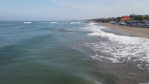 Aerial view of Canggu beach with surf people in afternoon alt