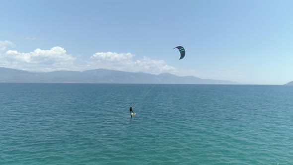 Aerial view of person kitesurfing in the Gulf of Patras, Greece. alt