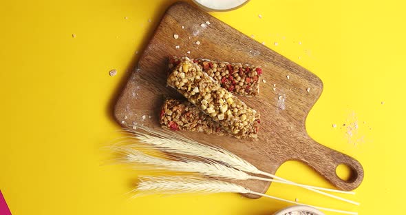 Cereal Bars and Oats on Wooden Board alt