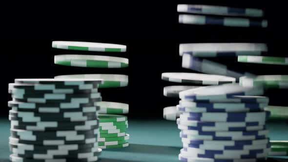 Casino chips or tokens forming stacks on a green gaming table. Winning. 4k alt