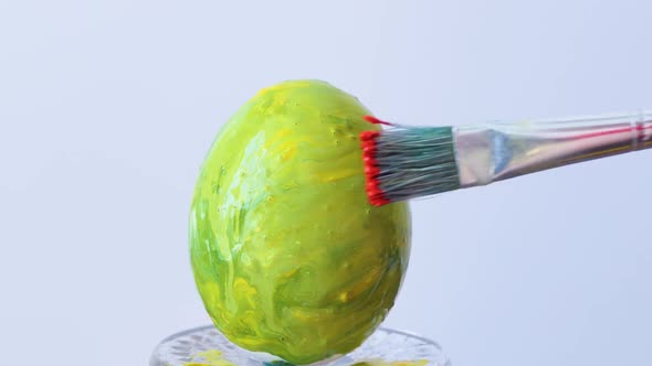 Closeup of a Person Painting Easter Eggs with a Special Brush alt