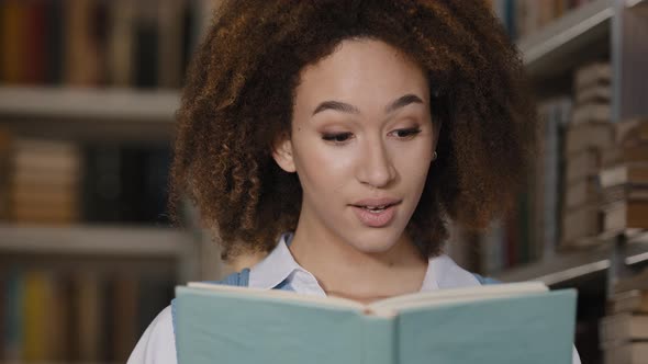 Closeup African American Girl Student Hiding Behind Textbook Reading Book Emotional Young Woman alt