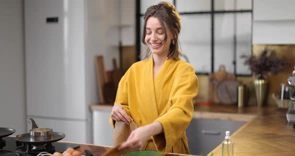 Woman Cooks Pancakes for Breakfast alt