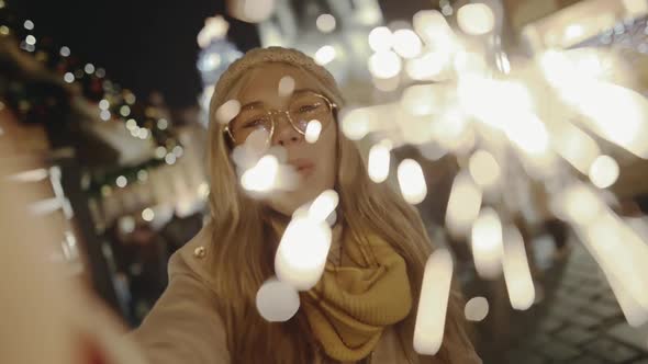 Gorgeous Blonde Smiling and Burning Bright Sparklers on New Year's Eve alt