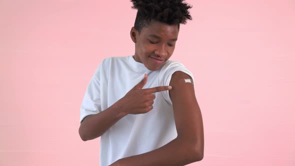 African American Teenager Showing COVID19 Vaccine Bandage Merrily alt