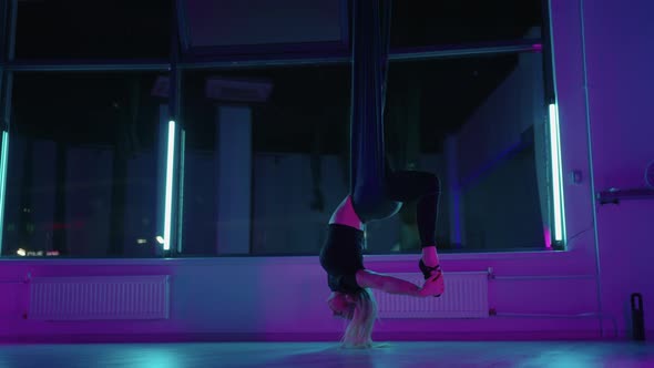 Yoga Asana in Hammock Woman is Practicing Antigravity Yoga in Fitness Club Healthy Lifestyle alt