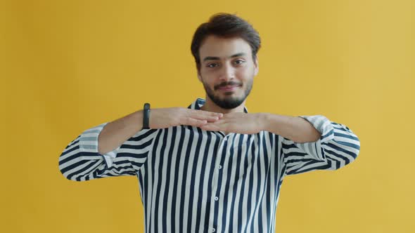 Funny Mixed Race Guy Dancing Moving Arms and Shoulders on Yellow Background