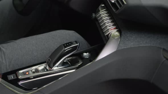Male Hand Shifts Gears. Automatic Transmission. Close-up alt