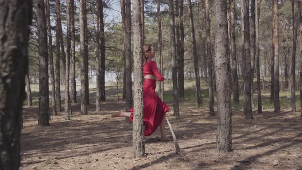 Skill Graceful Woman in Red Dress Dancing in the Forest Landscape. Beautiful Contemporary Dancer alt
