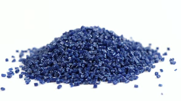 Secondary granule made of polypropylene. Dark blue plastic pellets crumbles on isolated background. alt